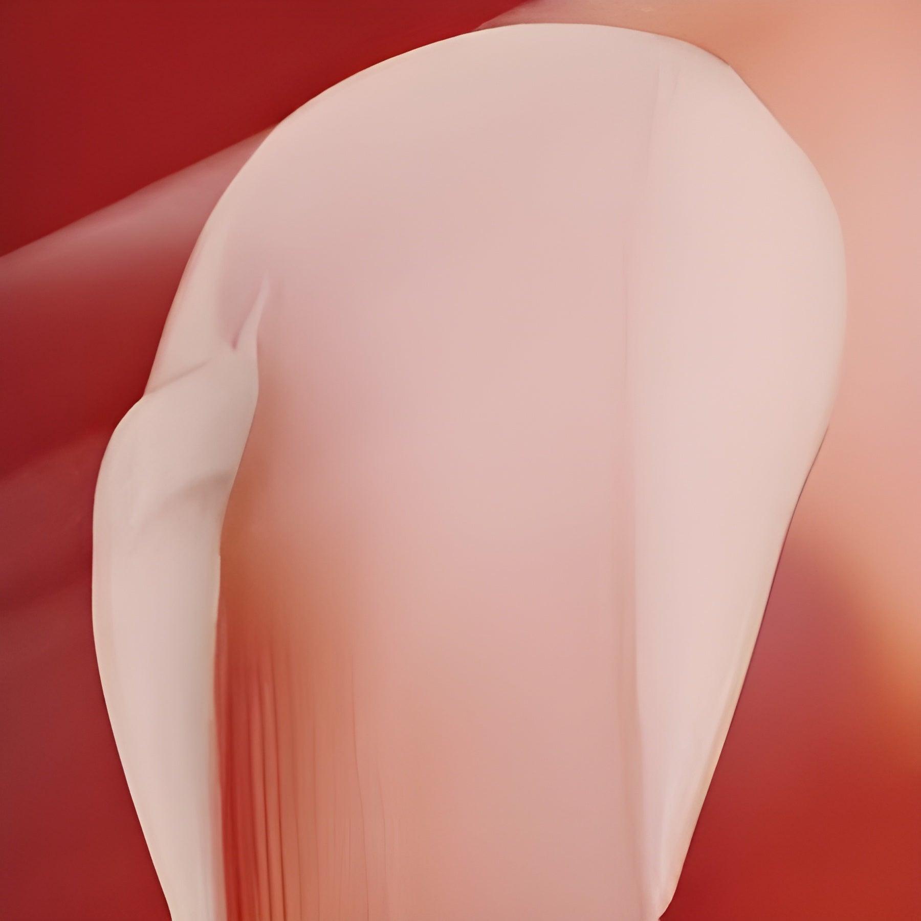 Eclat Soin Anti-Age Day Cream with Hyaluronic Acid in a smooth, creamy texture on a red background